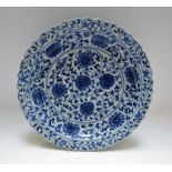 A Chinese shaped circular blue and white bowl, all over decorated with flowers, six character marks,