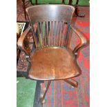 An early/mid-20th century oak swivel desk chair, curved cresting rail, straightened lath back,