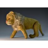 An early 20th century Steiff lion, hinged legs, white mane, floppy tail, replaced eyes,