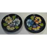 A pair of Moorcroft pin dishes, decorated with Pansies, marked M.C.C.