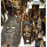 Tribal art - a large African mask; another; a carved bust of an African elder;