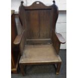 A mid 18th century ash and elm lambing chair, high wing back, stile feet, c.