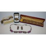 A continental silver seven link bracelet each link set with a mother of pearl panel each decorated