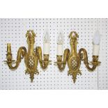 A pair of early 20th century gilt metal two light two branch wall sconces,