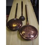 Two copper warming pans and a copper ponch.