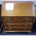 A mahogany bureau, the fall front enclosing a stepped and fitted interior, four graduated drawers.