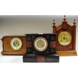 A Victorian slate mantel clock, circa 1870; a German mantel clock, circa 1890; an oak mantel clock,
