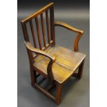An early 19th century elm child's chair, rectangular back with four splats, serpentine arms,