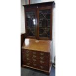 An early George III mahogany bureau bookcase, dentil cornice above a pair of astragal glazed doors,
