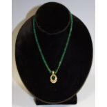 A raw Emerald rough stone necklace,