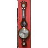 An early 20th century mahogany banjo barometer, swan neck pediment centred by an urnular finial,