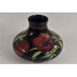 A Moorcroft Anemone pattern compressed ovoid vase, in shades of lilac,