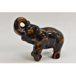 A Denby majolica elephant, in mottled tones of blue and brown, 14cm high, c.