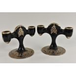 A pair of Rockwell glass two branch table candlesticks,