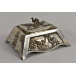 An unusual silver table box, the angular sides embossed with various panels,
