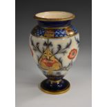 A Moorcroft McIntyre baluster shaped vase, decorated with stylised poppies and foliage, in red,