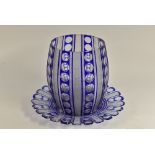 A large Bohemian glass blue flashed bowl on stand, engraved with bands of stars and roundels,