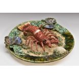 A Palissy style lobster plate, in relief with lobster and shells,