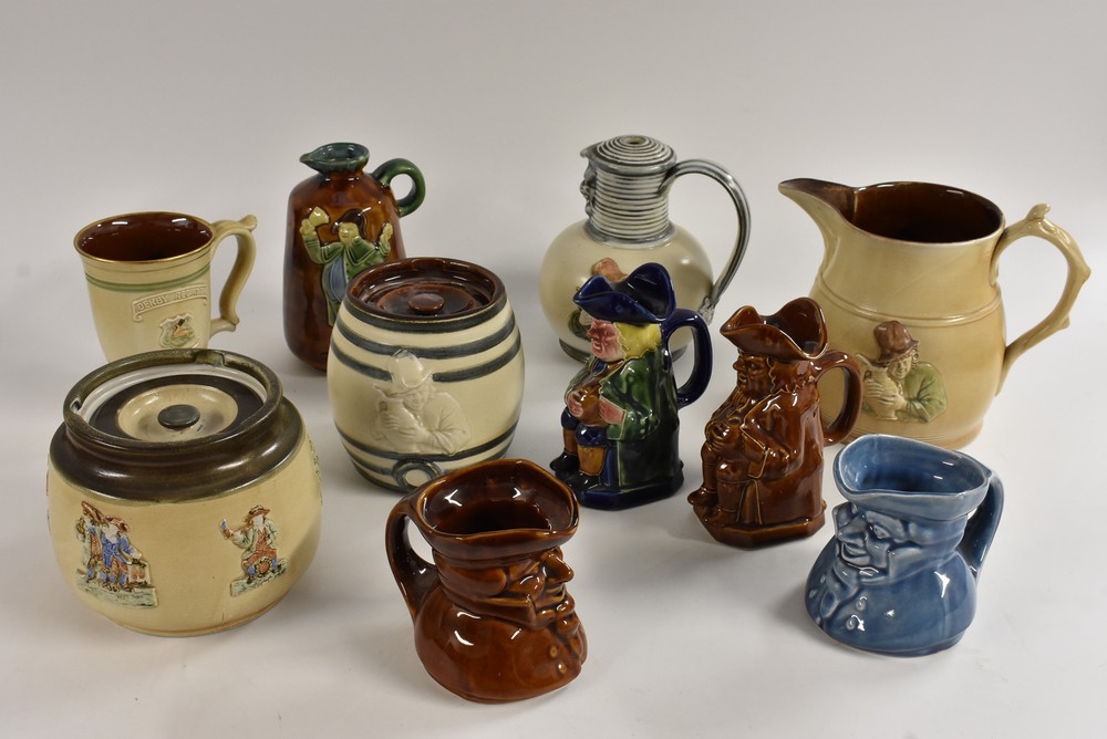 A Bourne Denby treacle glazed Toby jug, 15cm, printed mark; another in polychrome; a water jug,