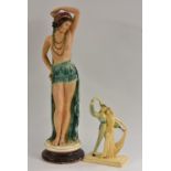 An Art Deco plaster figure, scantily clad dancing girl in provocative pose, stepped circular base,