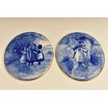 A pair of Doulton Burslem Blue Children oval wall plaques, painted with children in a woodland, 24.