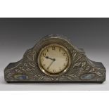 An Arts and Crafts mantel clock, the pewter case decorated with stylised repousse leaves,