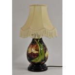 A Moorcroft Queens Fruit pattern baluster table lamp, tube lined with ripe peaches, figs,