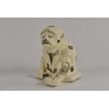 An interesting stoneware model of a sage looking ape, seated deep in meditation,