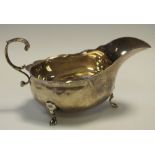 A George IV silver sauce boat, marks rubbed, foliate scrolled handle c.