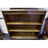 An oak floor standing bookcase, moulded top, adjustable shelving, ogee feet,