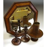 A pair of early 20th century oak barley twist candlesticks; an octagonal oak bevelled mirror;
