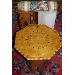 An octagonal marble plinth; marquetry octagonal table;