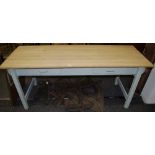 A pine kitchen table, stripped pine plant top, two short drawers to frieze, painted base,