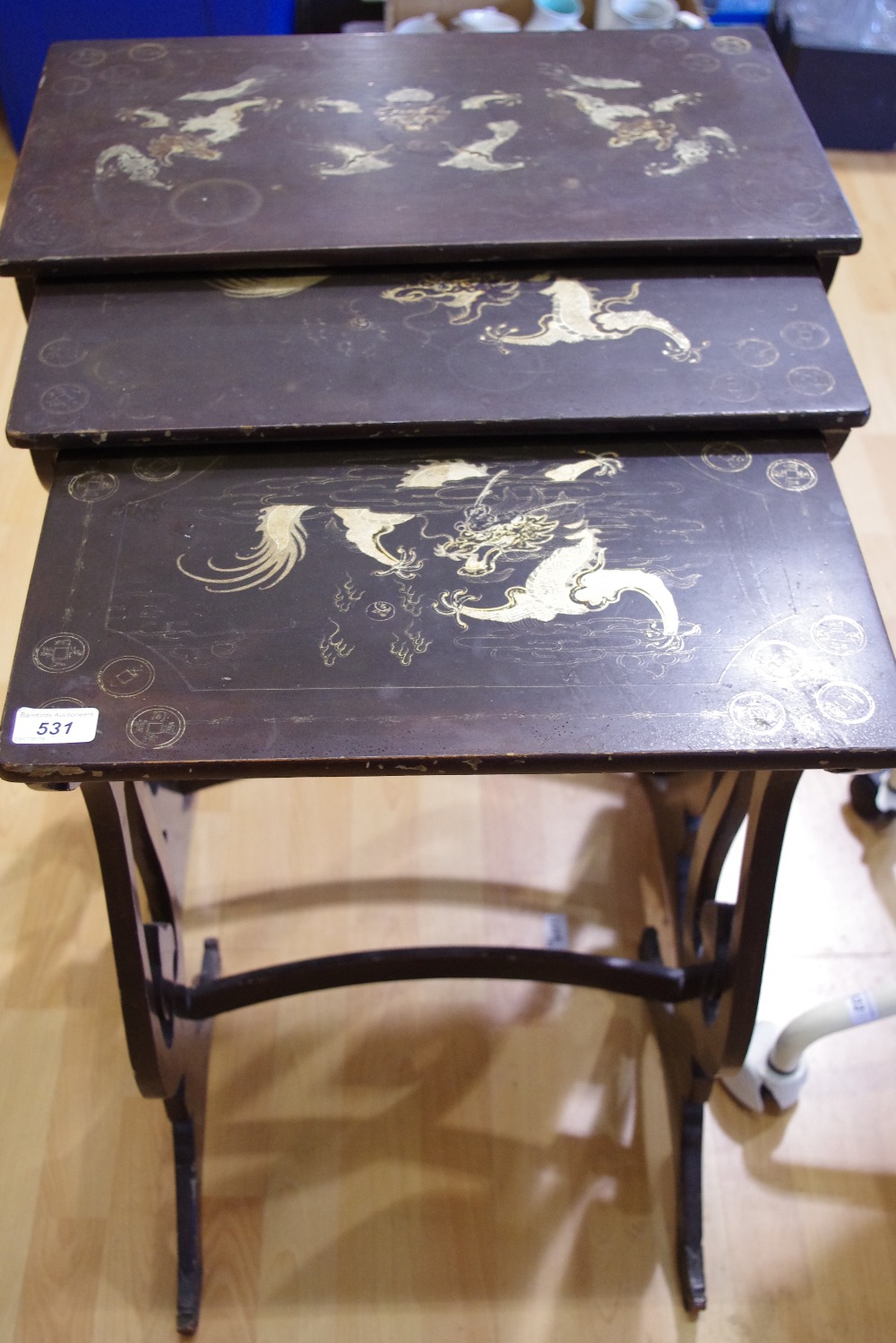 A Chinoiserie nest of three tables.