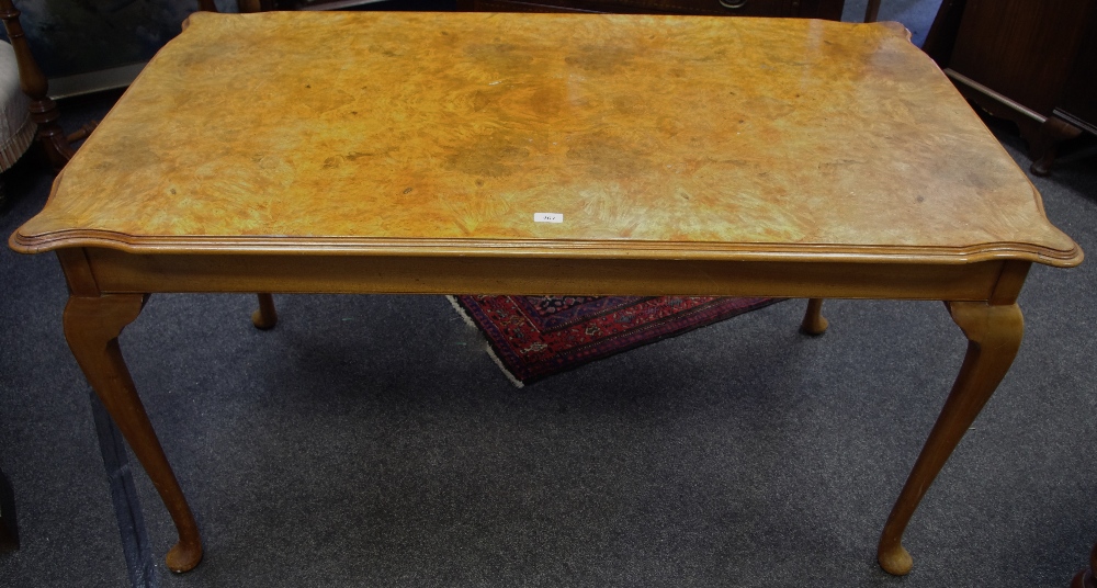 A Queen Anne style burr walnut veneered dining table, book matched veneered shaped rectangular top,