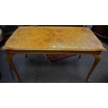 A Queen Anne style burr walnut veneered dining table, book matched veneered shaped rectangular top,