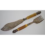 A pair of Victorian silver horn hafted fish servers, with foliage, horn hafts,