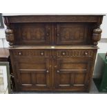 An Old Charm Court cupboard profusely carved throughout