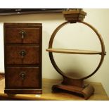 An Art Deco walnut smoker's stand; a walnut veneered three drawer bedside cabinet.