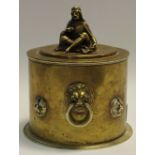 A brass tea caddy, lion mask handles, with four further lion masks,