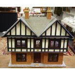 A Tudor style dolls house with six rooms,