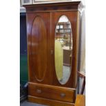 An Edwardian mahogany two piece bedroom suite comprising double wardrobe,