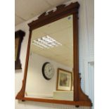 An Edwardian mahogany overmantel mirror, shaped pediment, rectangular bevel edge glass.