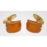 A pair of yellow metal Art Deco gold cufflinks set with butterscotch and cognac amber,