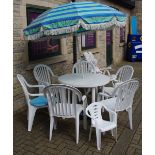 A garden patio set comprising table, parasol, six chairs,