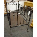 A Victorian cast iron and brass cot.