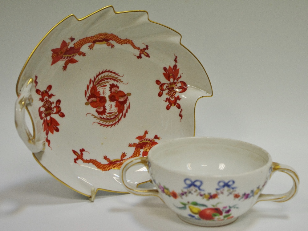 A Meissen leaf shaped dish, painted with a red dragons, gilt line rim, rustic loop handle,