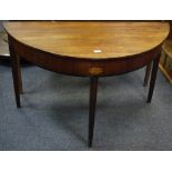 A George III mahogany demi-lune table, inlaid with patera.