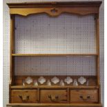 A farmhouse pine hanging open shelf unit with three drawers