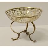 An Edwardian silver sweet meat basket, raised on a tripod base, pierced decoration,